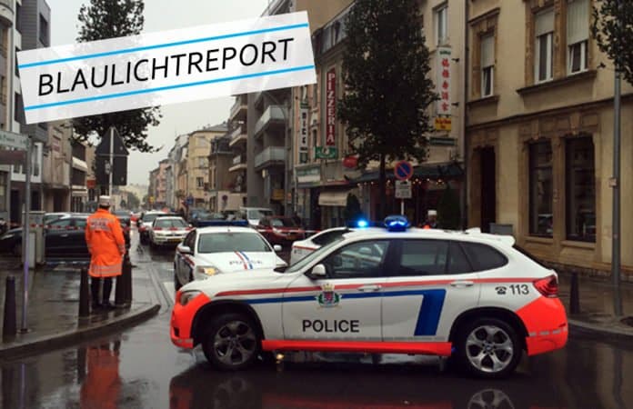 Symbolbild für die Verfolgungsjagd in Luxemburg. Ein Polizeiwagen sperrt eine Straße ab. Es regnet.