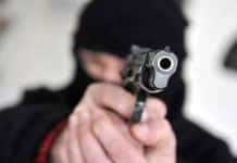 Überfall auf Tankstelle: Mitarbeiterinnen mit Handfeuerwaffe bedroht und gefesselt Maskierter Mann mit Pistole